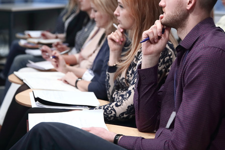 Concentrated young business people listening report about companyの写真素材