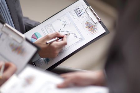 Close up of business people hands pointing growing financial buの写真素材