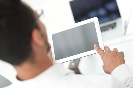 rear view.modern man uses a digital tabletの写真素材