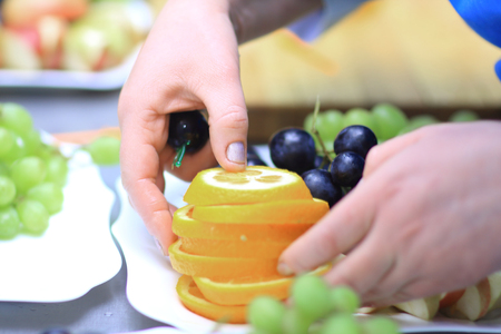 close up. the chef decorates a plate of grapesの写真素材