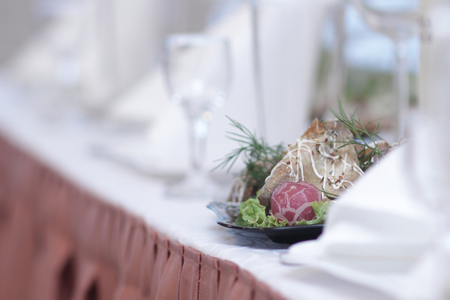 blurred image of a bottle of wine and appetizer on the tableの写真素材