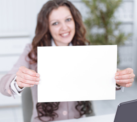 young business woman showing blank sheet of paperの写真素材