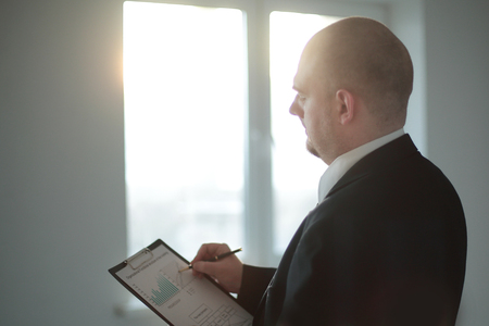 close up.the businessman checks the financial schedule.の写真素材