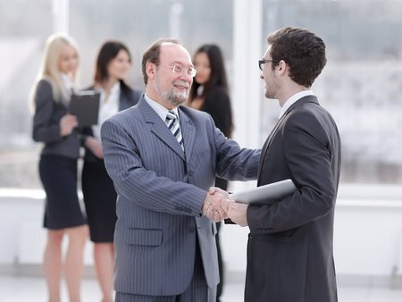 project Manager shaking hands with the employee prior to the seminarの写真素材
