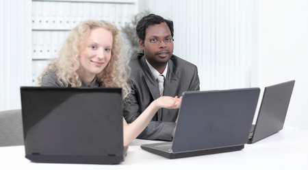 younger employees discussing business issues in officeの写真素材