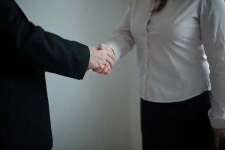 close up.handshake business woman and businessman standing in office