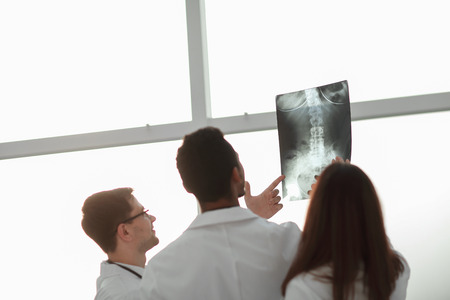 rear view. doctors looking at the x-ray of the patient .