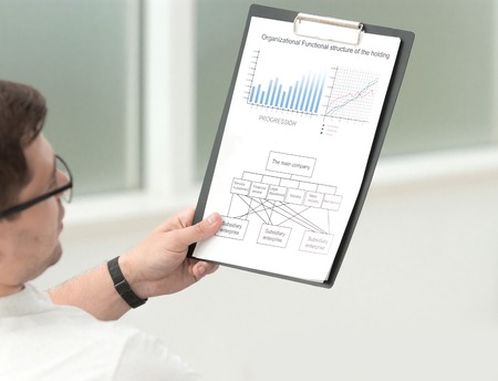 close up.serious businessman with business documents sitting near his office Deskの写真素材