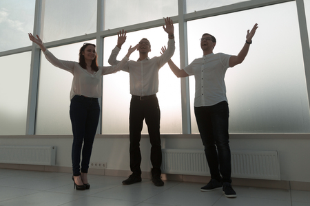 young business team standing in a bright officeの写真素材