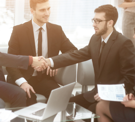 close up.the financial partners shaking hands over Deskの写真素材