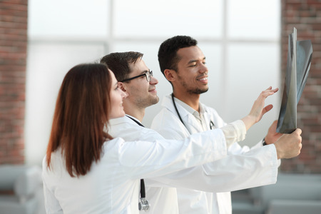 group of medical doctors discussing the patients x-ray.の写真素材