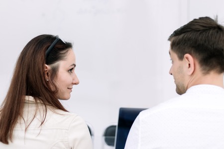 rear view. business colleagues sitting at the office Deskの写真素材