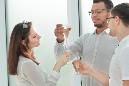 close up. business partners clink their glasses with wine.の写真素材