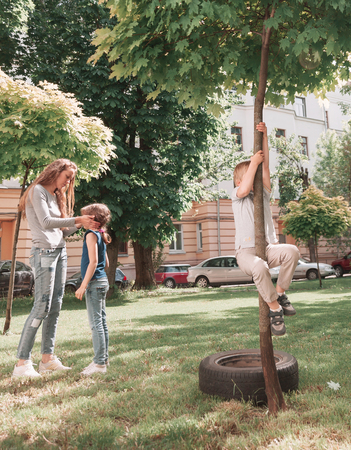 mother and children playing in the city yard.の写真素材