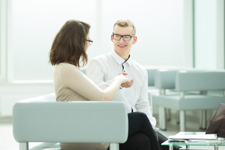 business partners shaking hands sitting in the Bank officeの写真素材