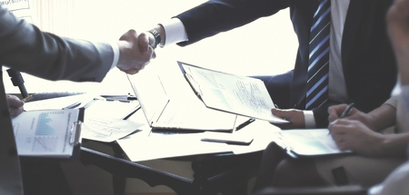 handshake of senior business partners on the Deskの写真素材