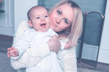 small child in the arms of mom . positive human emotions, feelの写真素材