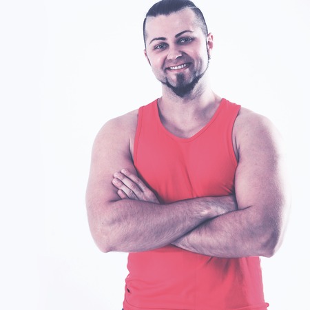 portrait of a sporty guy - bodybuilder in jeans and orange t-shiの写真素材