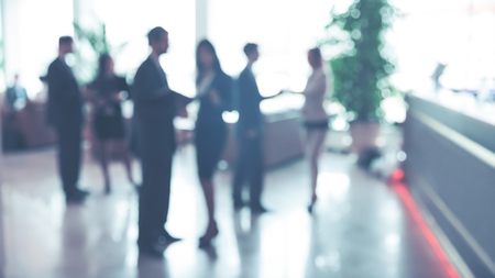 Blurred background : employees work in the lobby, spacious officeの写真素材