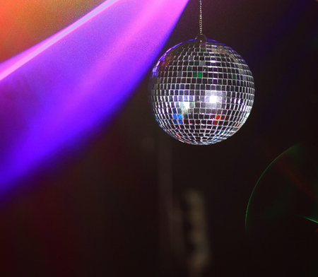 hand DJ holds disco ball. photo with copy spaceの写真素材
