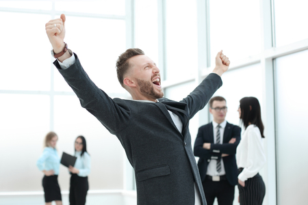 happy businessman standing in the hall of the business centeの写真素材