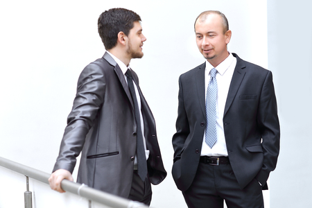 two employees talking in the hallway of the officeの写真素材