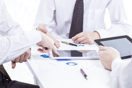 business team with digital tablet and smartphone working with financial chartsの写真素材