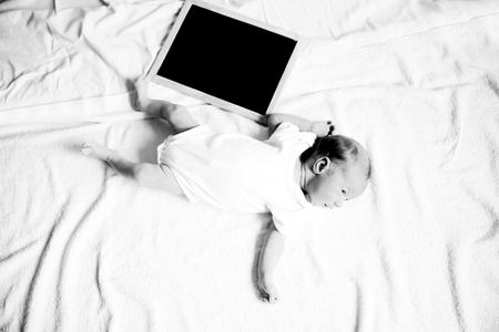 black-and-white photo in retro style: a portrait of a newborn baの写真素材