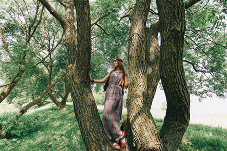 young woman hippy near a big treeの写真素材