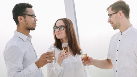 close up.business team holding a glass of wine.の写真素材