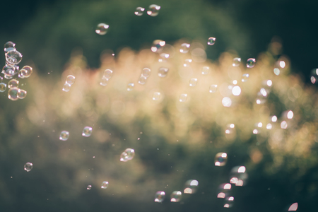 lots of soap bubbles on blurred grass backgroundの写真素材