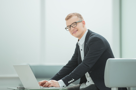 businessman uses a laptop to work with documentsの写真素材