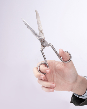 Man holding scissors on white backgroundの写真素材