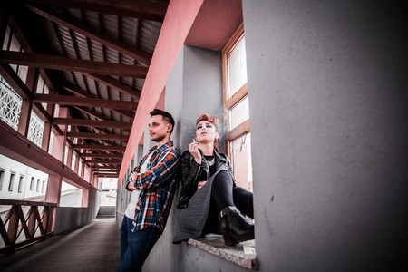 young woman and her boyfriend quarrel in the entrance of a house