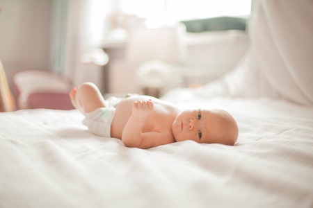 pretty newborn baby lying on a light blanket .