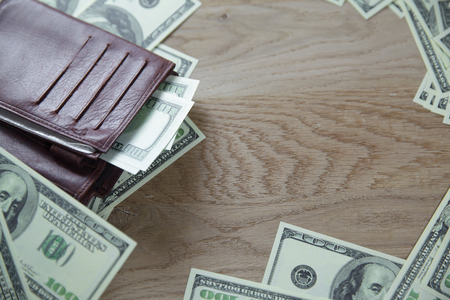 close up.wallet and dollar bills on wooden background.business conceptの写真素材