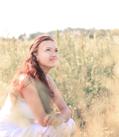 Young woman on spring meadow.の写真素材