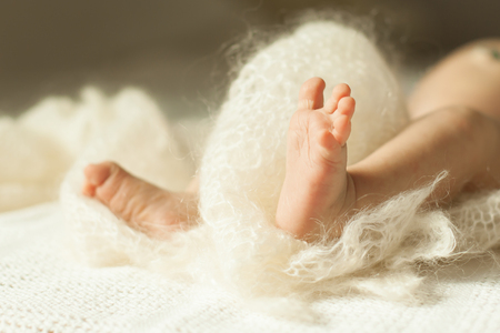 Image of a newborn baby lying on the couch in the nurseryの写真素材