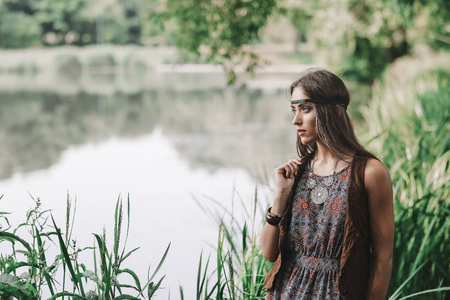 beautiful hippie girl on spring forest backgroundの写真素材