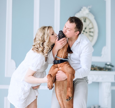 portrait of a young married couple kissing their petの写真素材