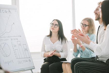 group of businesspeople clapping hands during meeting presentationの写真素材