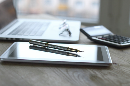 close up.fountain pen, tablet and laptop on the table.business backgroundの写真素材