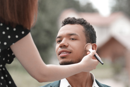 makeup artist makes makeup young politician before a public speechの写真素材