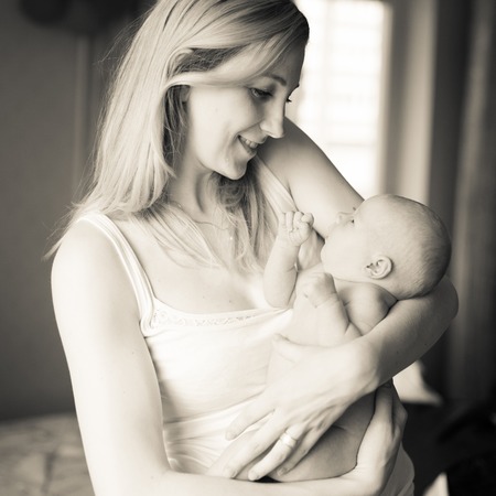 retro photo. happy mother with a pretty novorojdennih daughter .