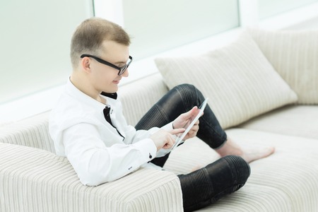 smiling man reading text on digital tabletの写真素材