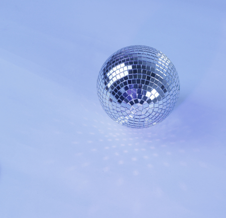 beautiful disco ball on yellow background isolated.の写真素材