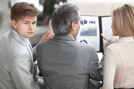rear view .the business team checks the financial statementの写真素材