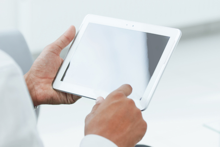close up. businessman tapping the screen of the digital tabletの写真素材