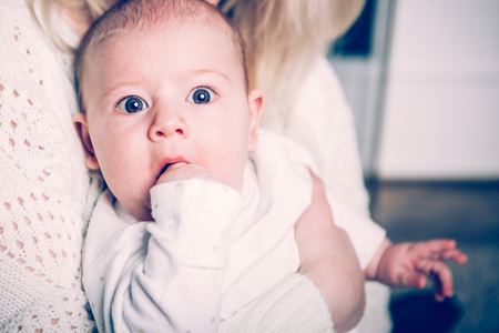 a small child in the arms of mom . positive human emotions, feelings