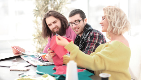 group of designers discussing fabric samples in the Studio